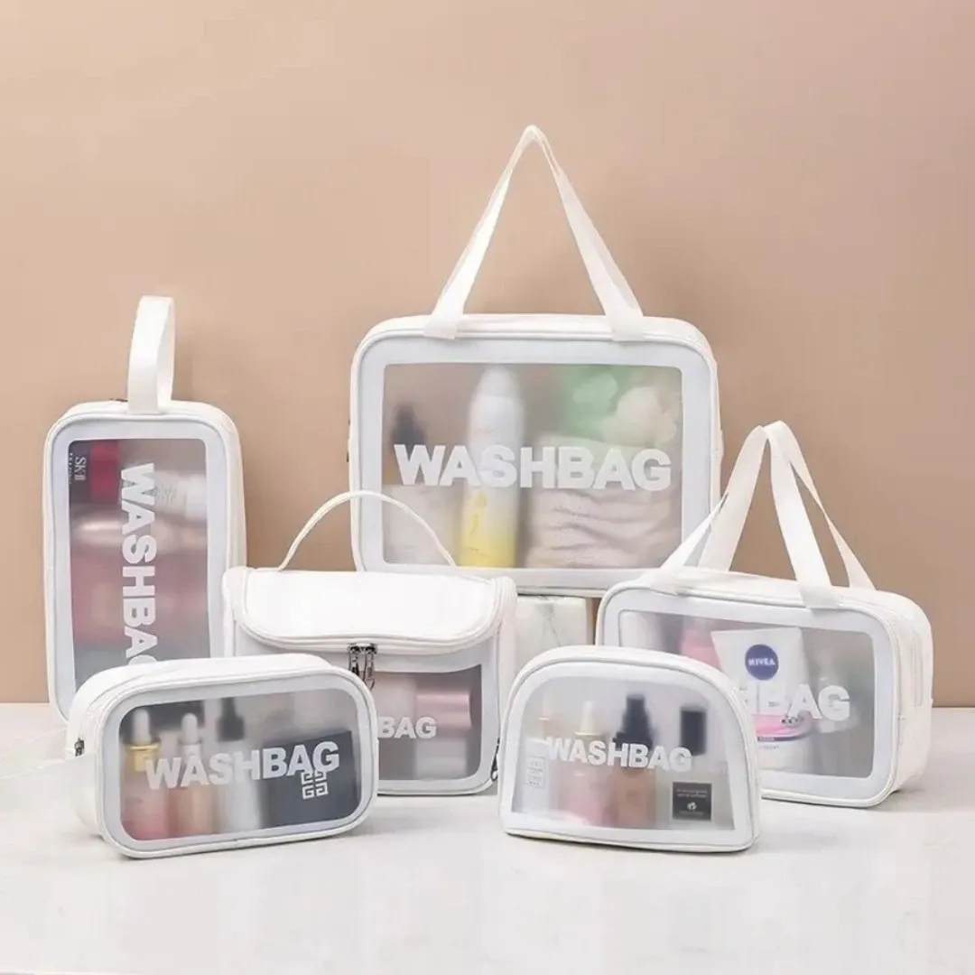 Set of clear white wash bags in multiple sizes, arranged on a neutral background and shown with travel toiletries inside to demonstrate capacity and visibility.